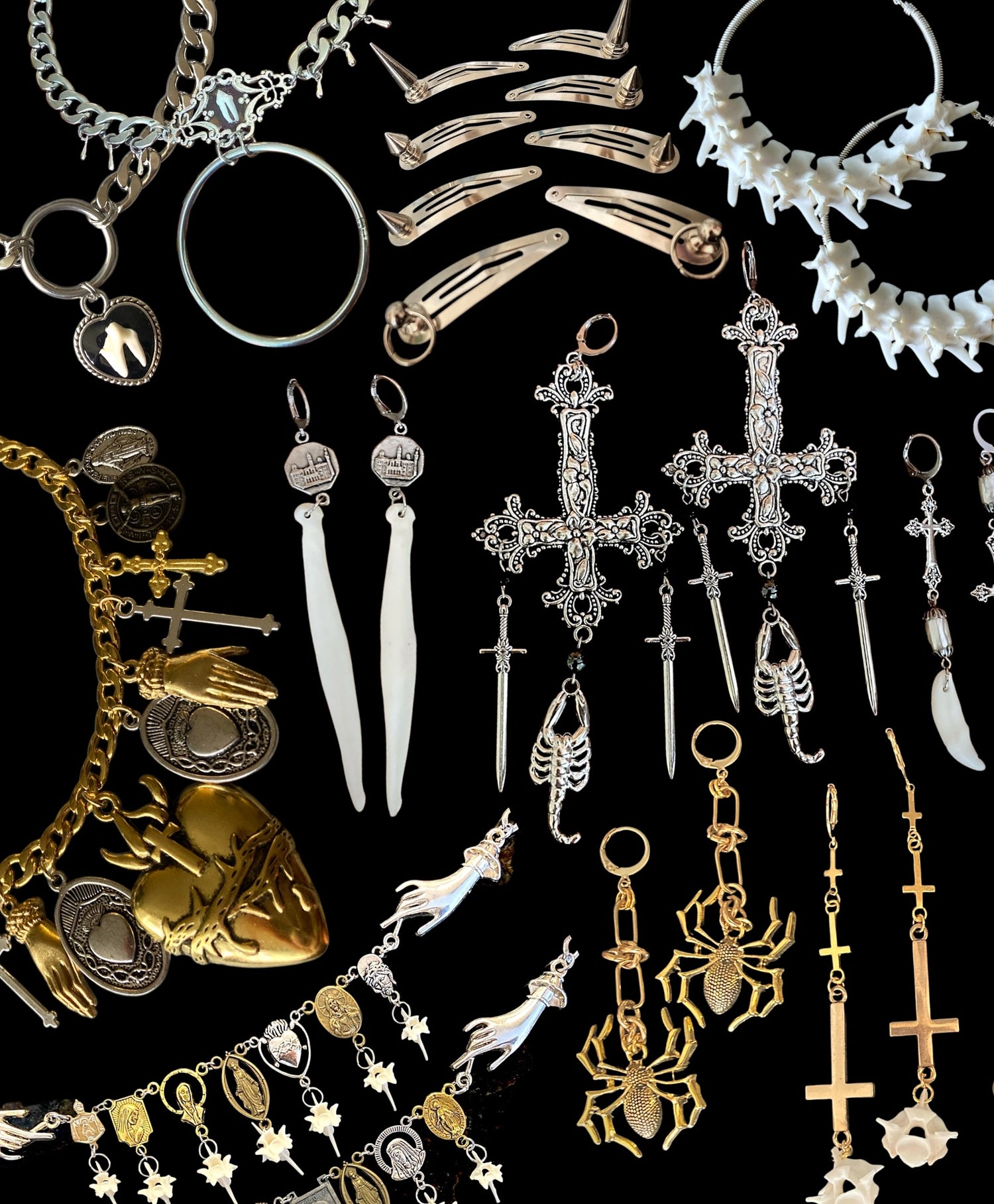 Collection of various jewelry items including necklaces, earrings, and pendants on a black background.